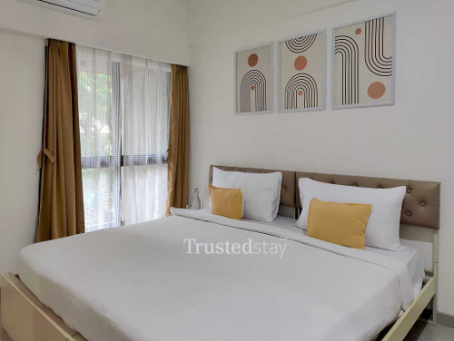 Deluxe Bedroom of TrustedStay ZBliss Suites Service Apartment in Kurla West, Mumbai